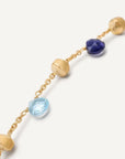 Gold bracelet with blue gemstones on a white background close up