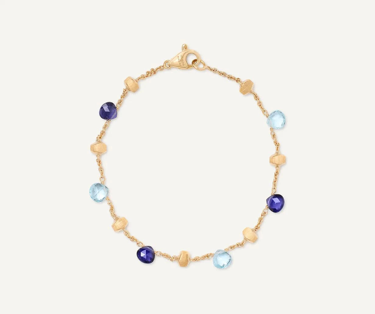 Gold bracelet with blue and purple gemstones on a white background