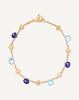 Gold bracelet with blue and purple gemstones on a white background