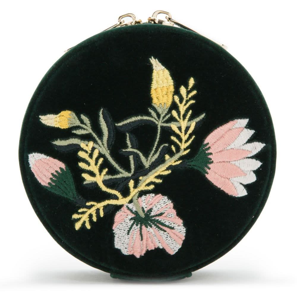 Round black velvet case with floral embroidery on a white background