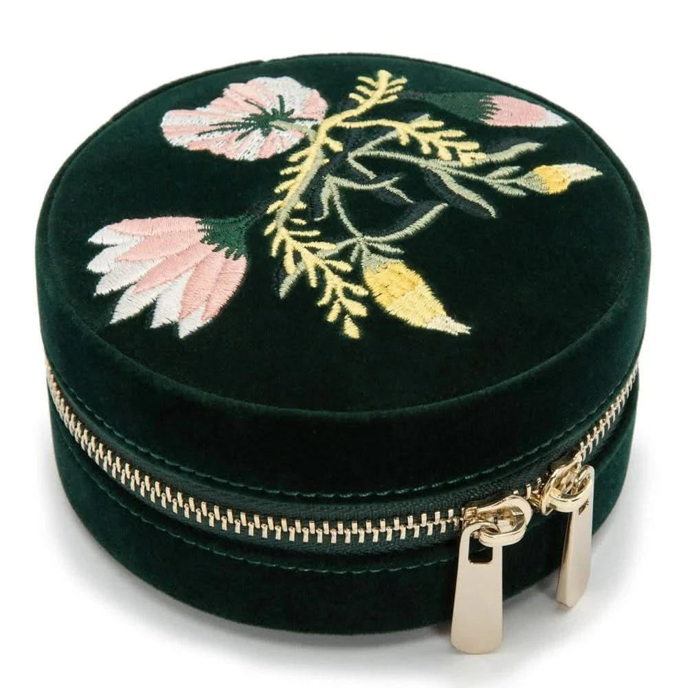 Round black velvet case with floral embroidery on a white background top view