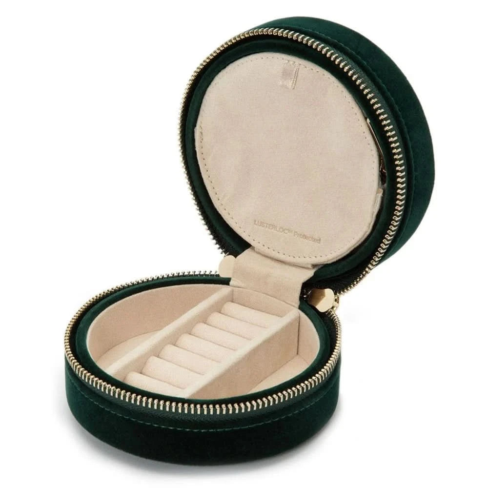 Round black velvet case with beige inside compartments for rings and side compartments