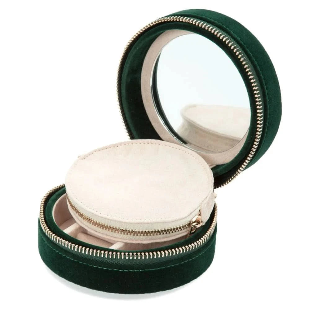 Green round jewelry box with mirror lid on a white background