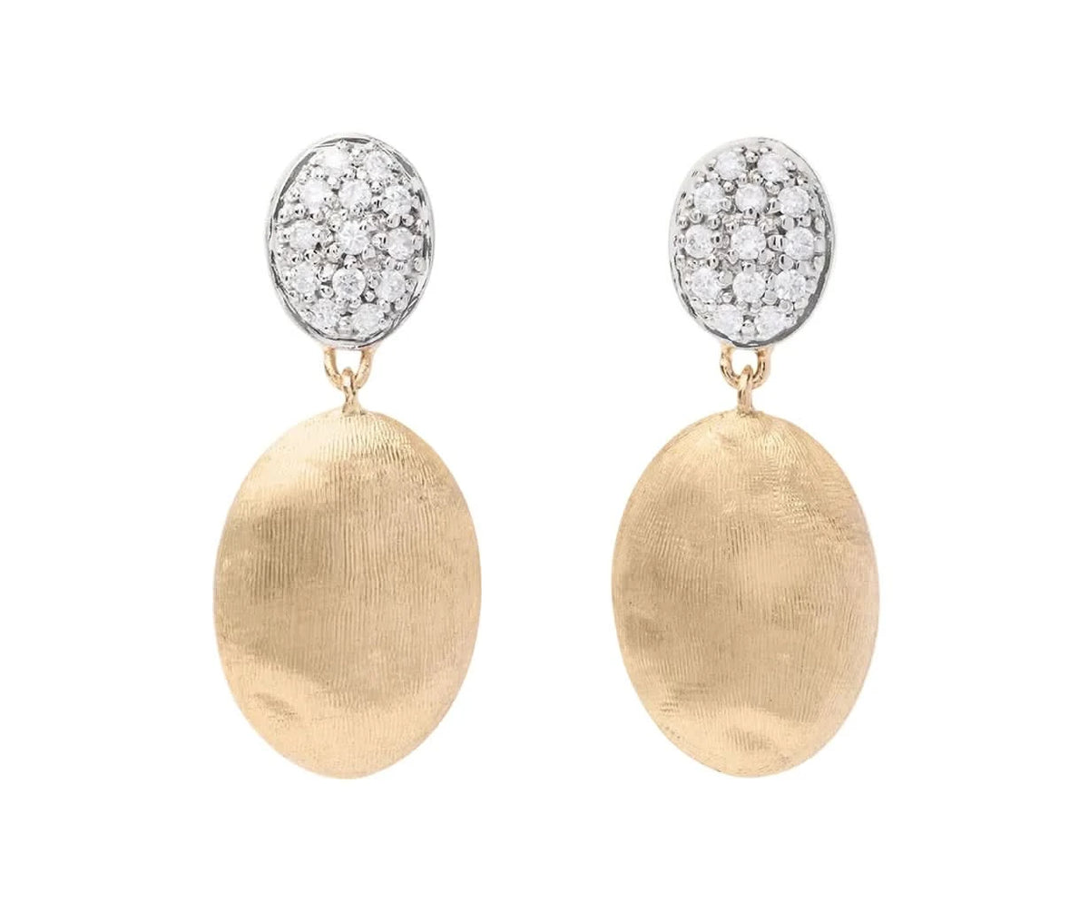 A pair of gold and silver drop earrings featuring textured oval gold drops and oval white gold paved with diamond tops, shown against a light off-white background.