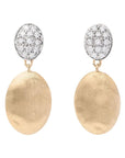 A pair of gold and silver drop earrings featuring textured oval gold drops and oval white gold paved with diamond tops, shown against a light off-white background.