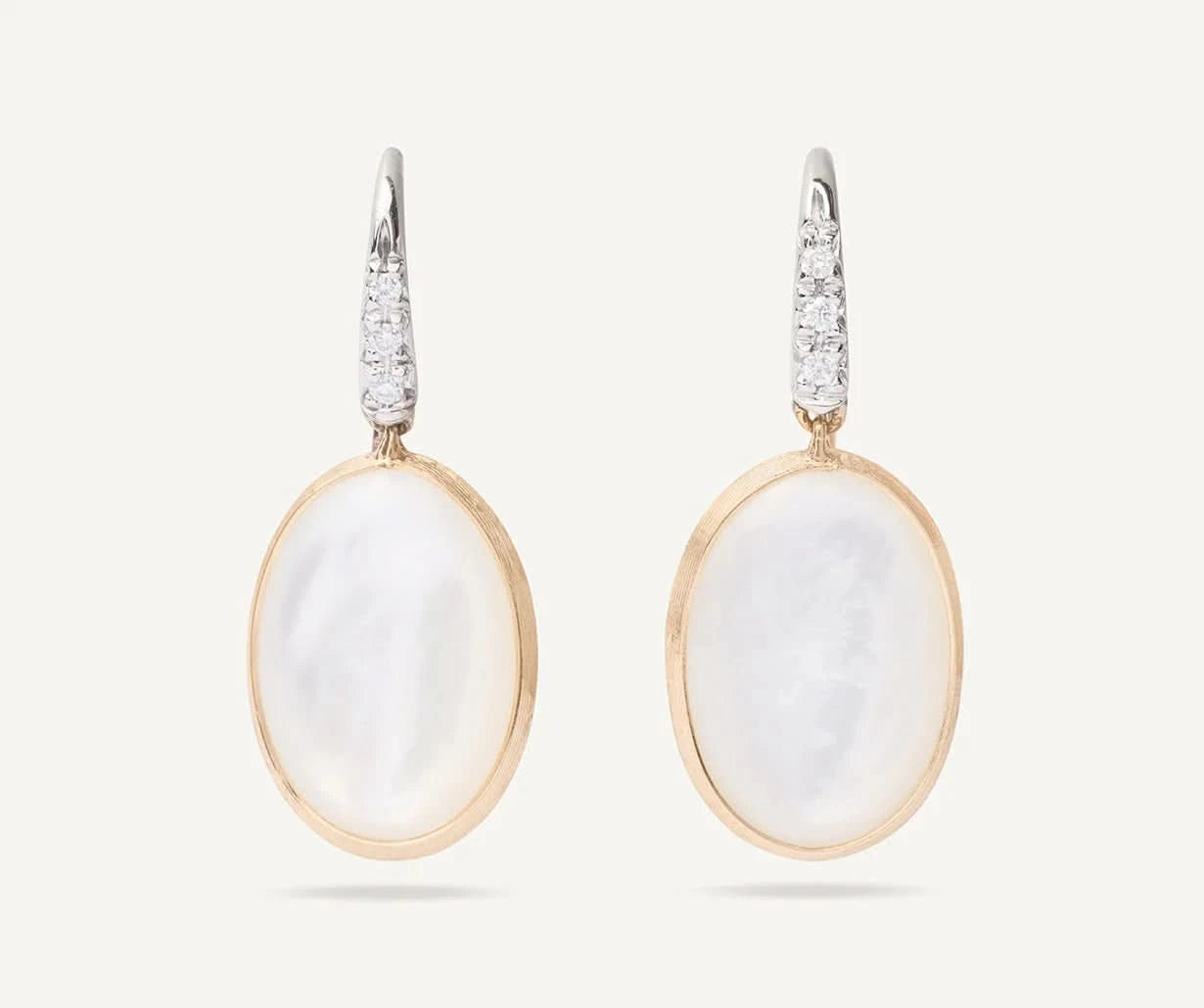 Pair of earrings with white  mother of pearl stones and gold frames on a white background