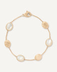 Gold bracelet with mother of pearl stones on a white background