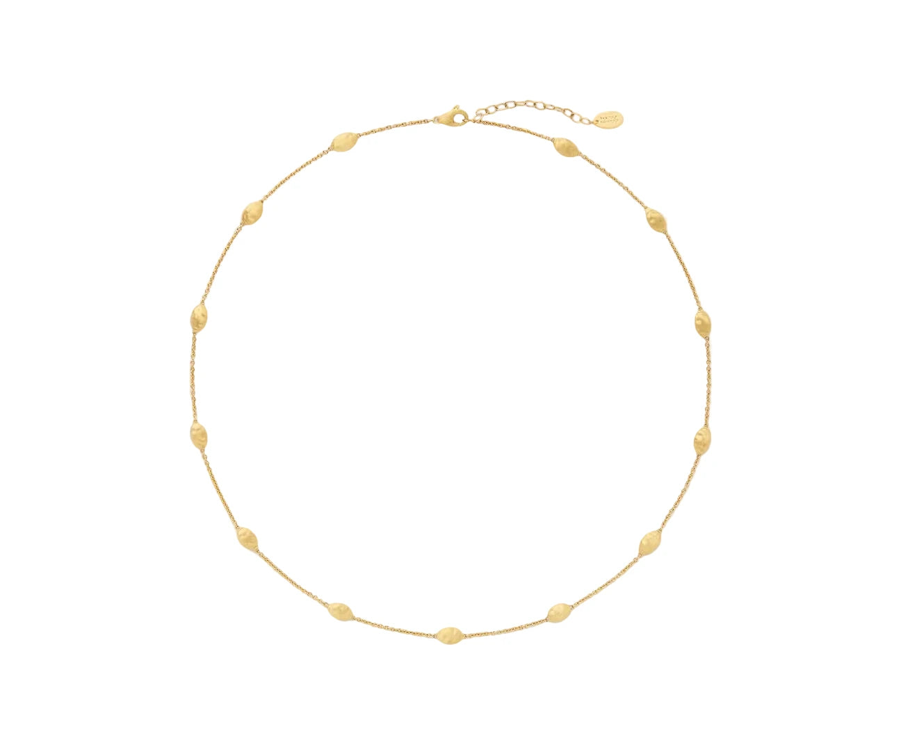 Gold necklace on a light beige background