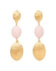 A pair of gold drop earrings featuring a textured round gold top, a smooth pale pink oval bead, and a larger textured gold oval drop, shown against a light off-white background.