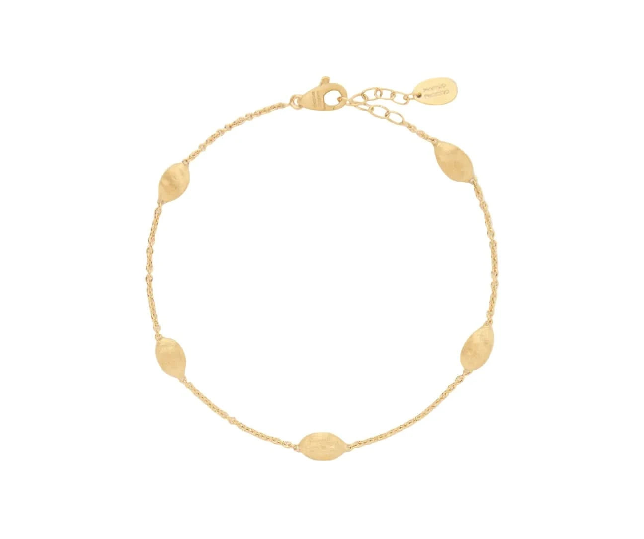 Gold bracelet with ovalshaped charms on a light beige background