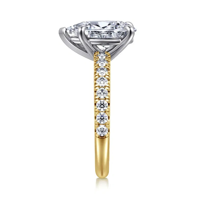 Diamond ring with a yellow gold band on a white background