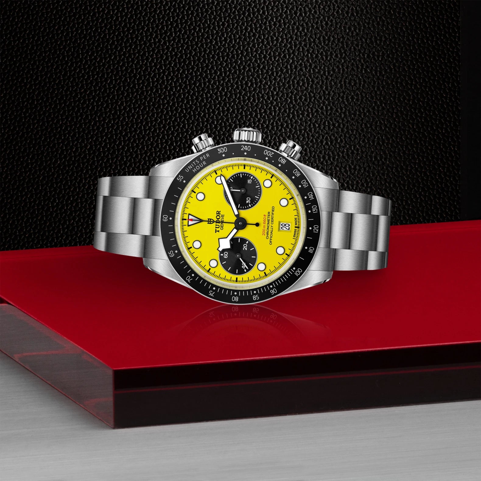 Tudor Black Bay Chrono Yellow Dial - Closed Bracelet laying posed on red surface with black background