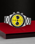 Tudor Black Bay Chrono Yellow Dial - Closed Bracelet laying posed on red surface with black background