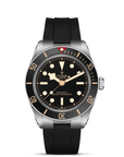 Tudor watch with black strap and black dial on a white background