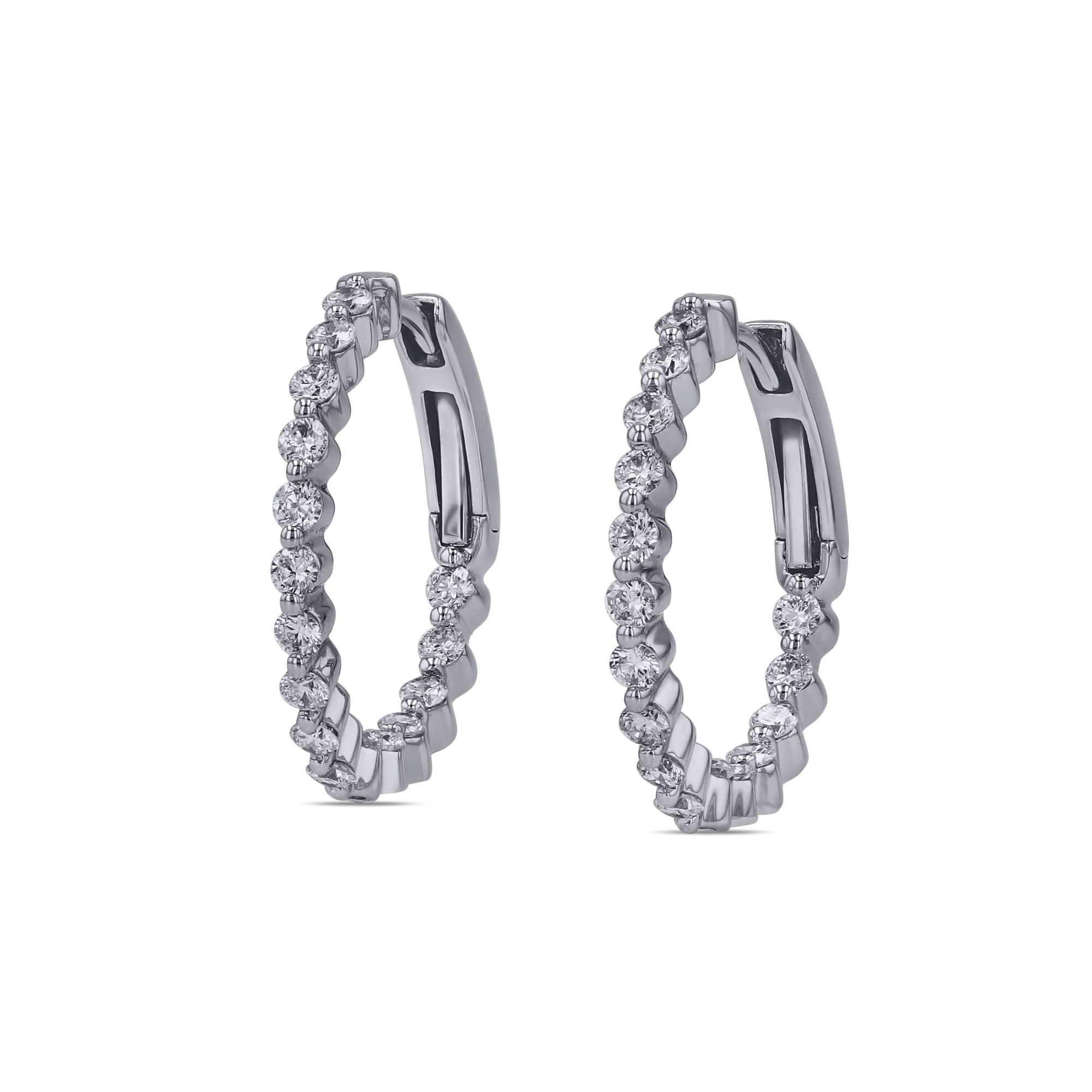 Pair of white gold  hoop earrings with diamonds on a white background