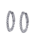 Pair of white gold  hoop earrings with diamonds on a white background