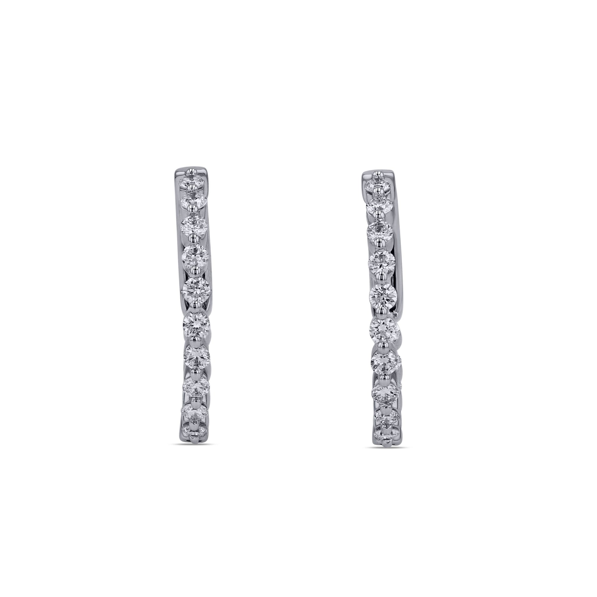 Pair of diamond hoop earrings on a white background