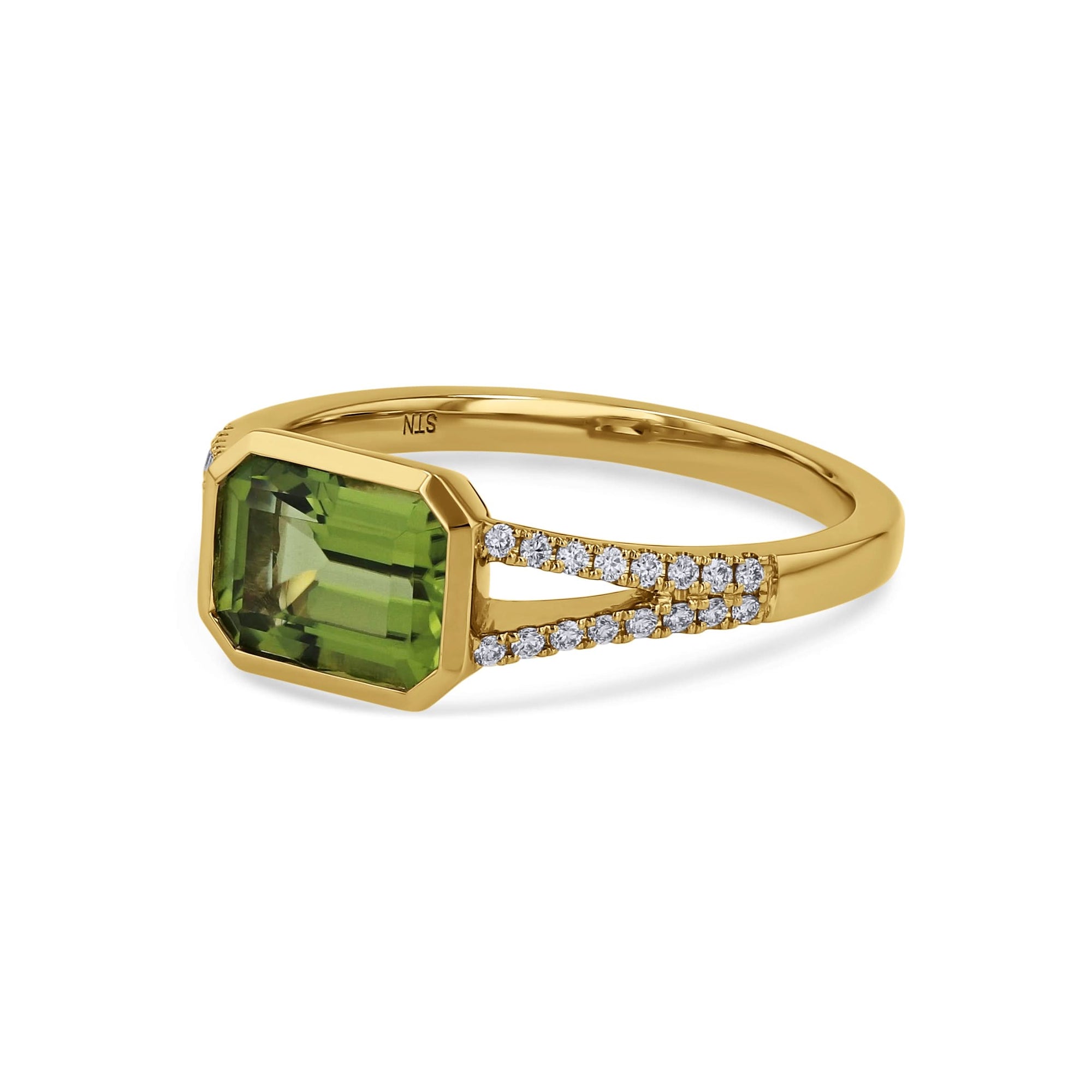 side view of yellow gold ring with green center and diamonds on a white background