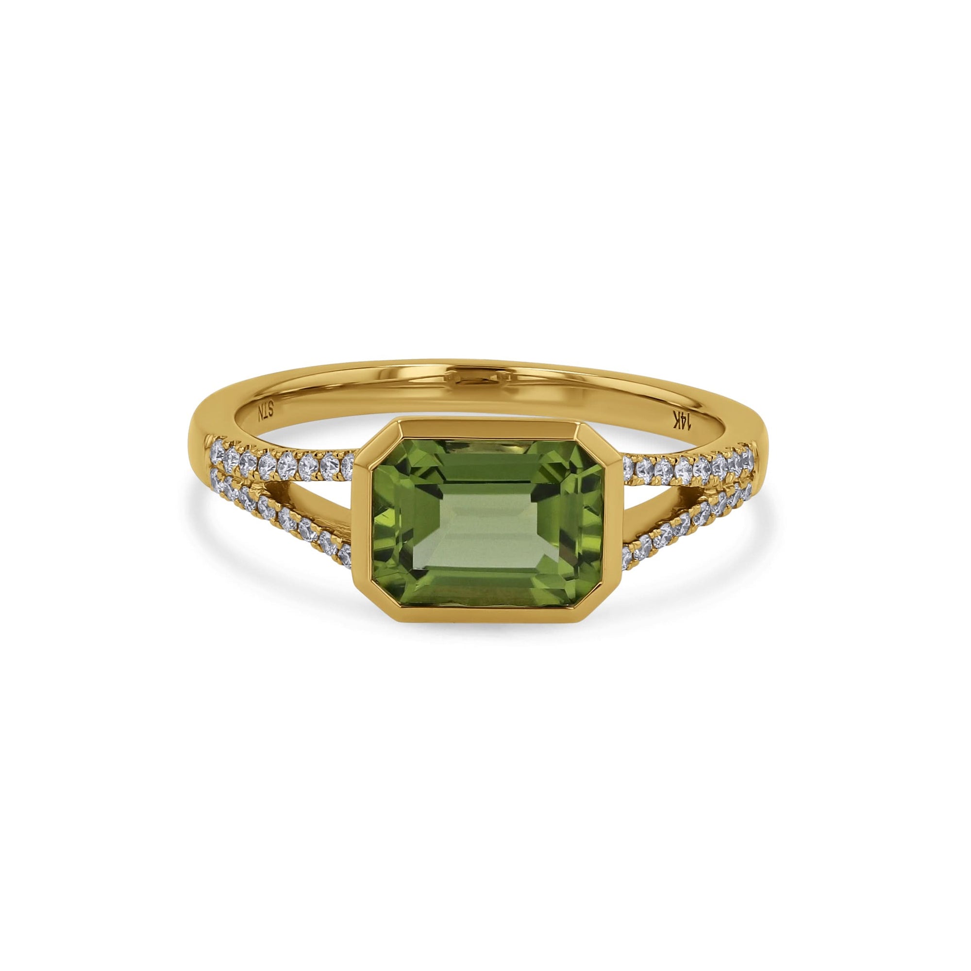 yellow gold ring with a green bezel center and embedded diamonds on a white background