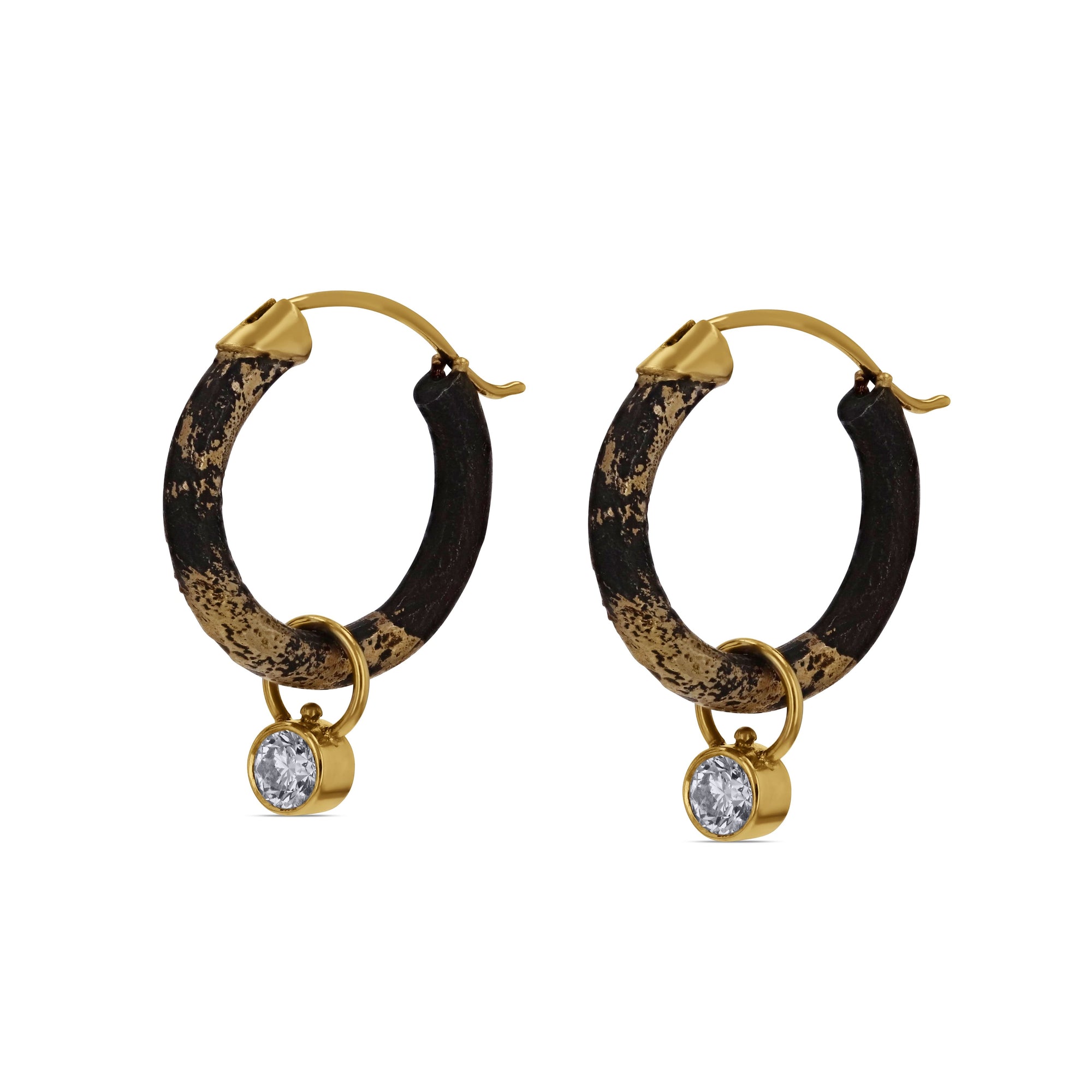 Black Pair of hoop earrings with gold accents and diamonds on a white background