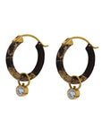 Black Pair of hoop earrings with gold accents and diamonds on a white background