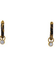 Pair of gold hoop earrings with black accents and small round stones on a white background