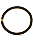 Black circular bracelet with gold accents on a white background