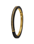 Gold and black bracelet with diamond accents on a white background