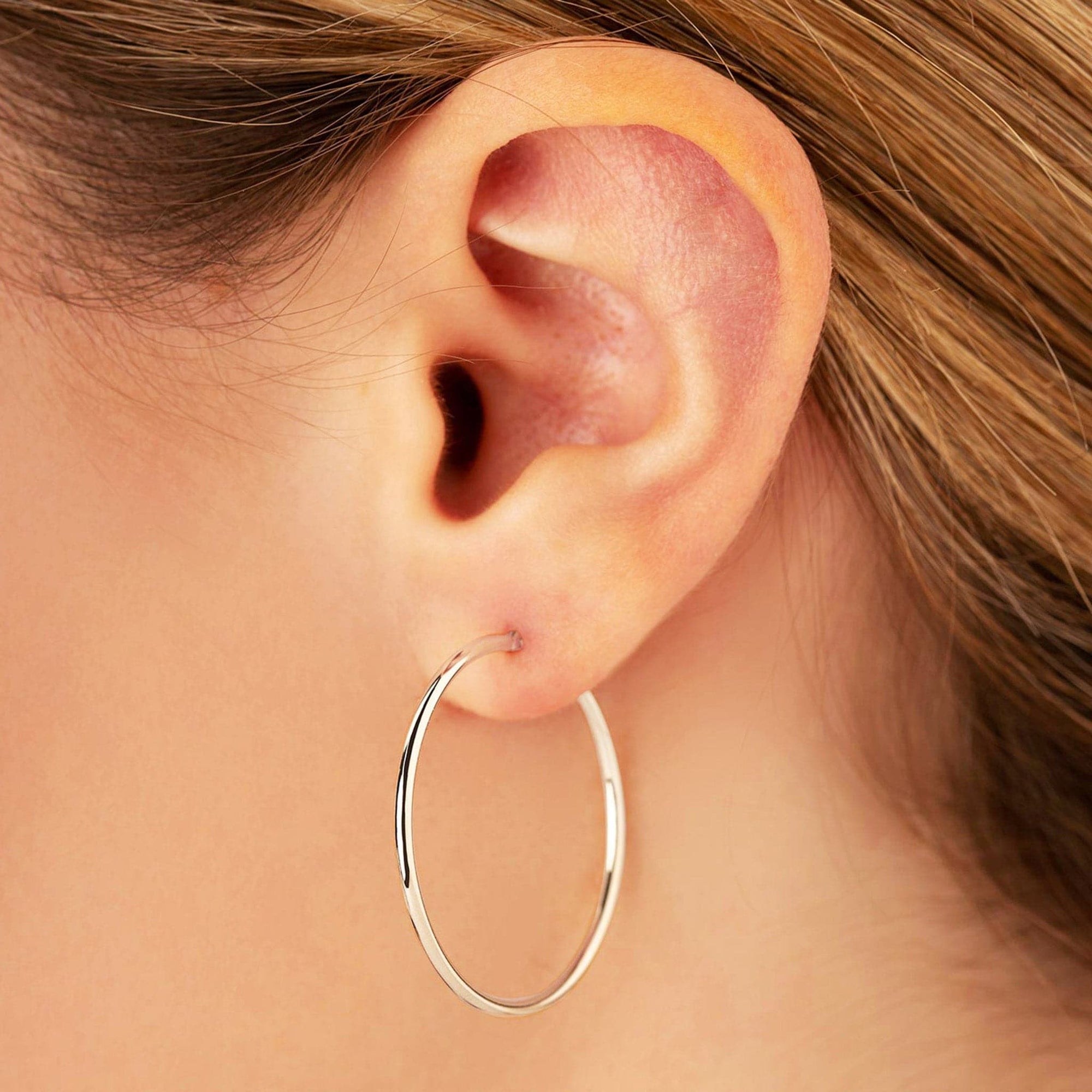 White Gold Tube Hoop Earrings by Carla | Nancy B.