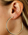 Large Yellow Gold Tube Open Hoop Earrings by Carla | Nancy B. Modeled