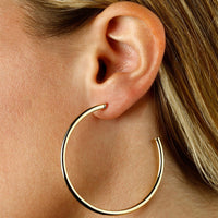 Large Yellow Gold Tube Open Hoop Earrings by Carla | Nancy B. Modeled