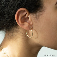 1.5 x 25mm Yellow Gold Tube Hoop Earrings by Carla | Nancy B. Modeled