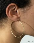 Yellow Gold Tube Hoop Earrings by Carla | Nancy B. 1.5x50mm modeled