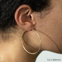 Yellow Gold Tube Hoop Earrings by Carla | Nancy B. 1.5x50mm modeled
