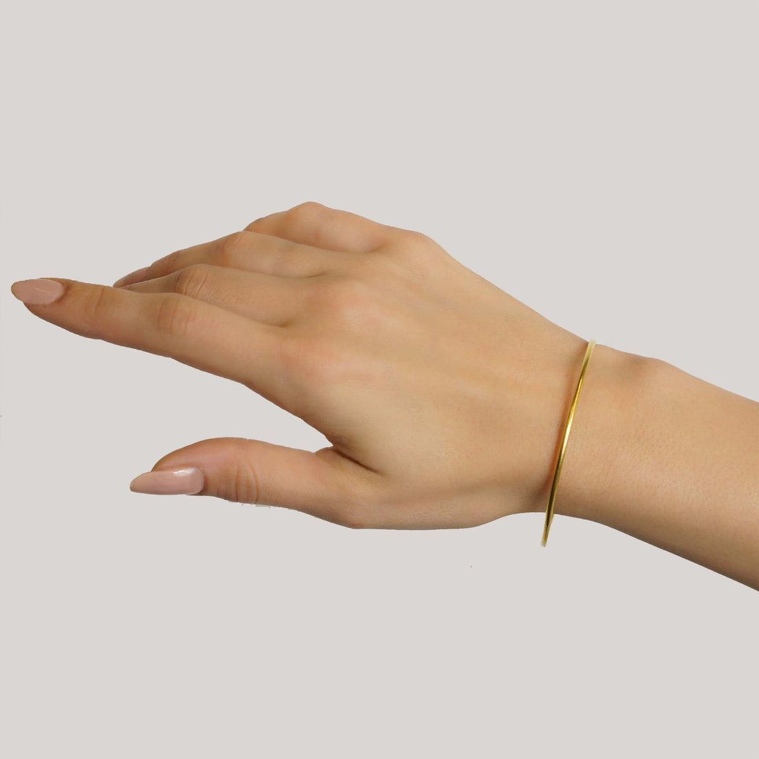 Lika Behar Yellow Gold 2mm Thin Bangle Bracelet modeled