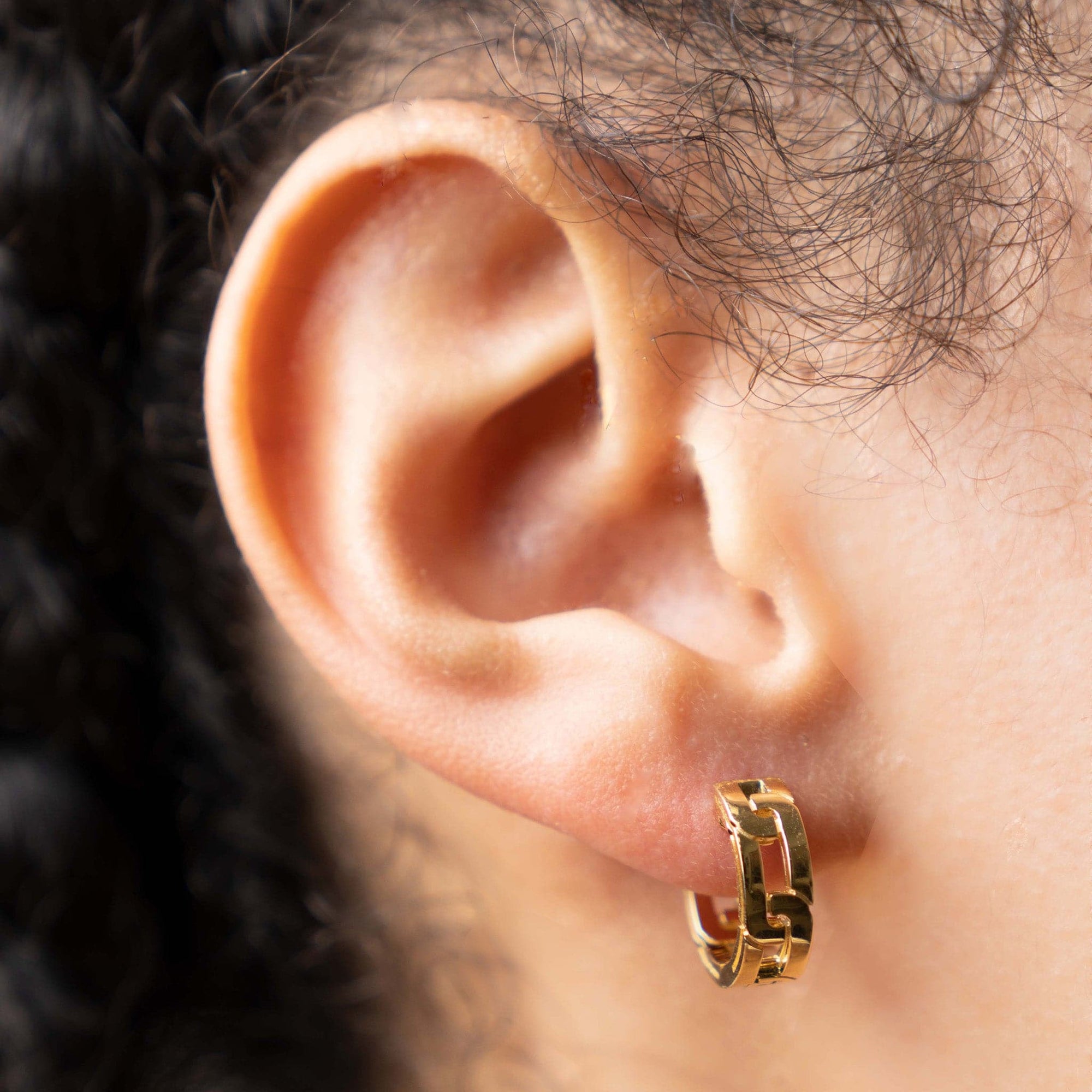 Close up of ear wearing Roberto Coin Huggies Navarra 18k Yellow Gold Earrings 